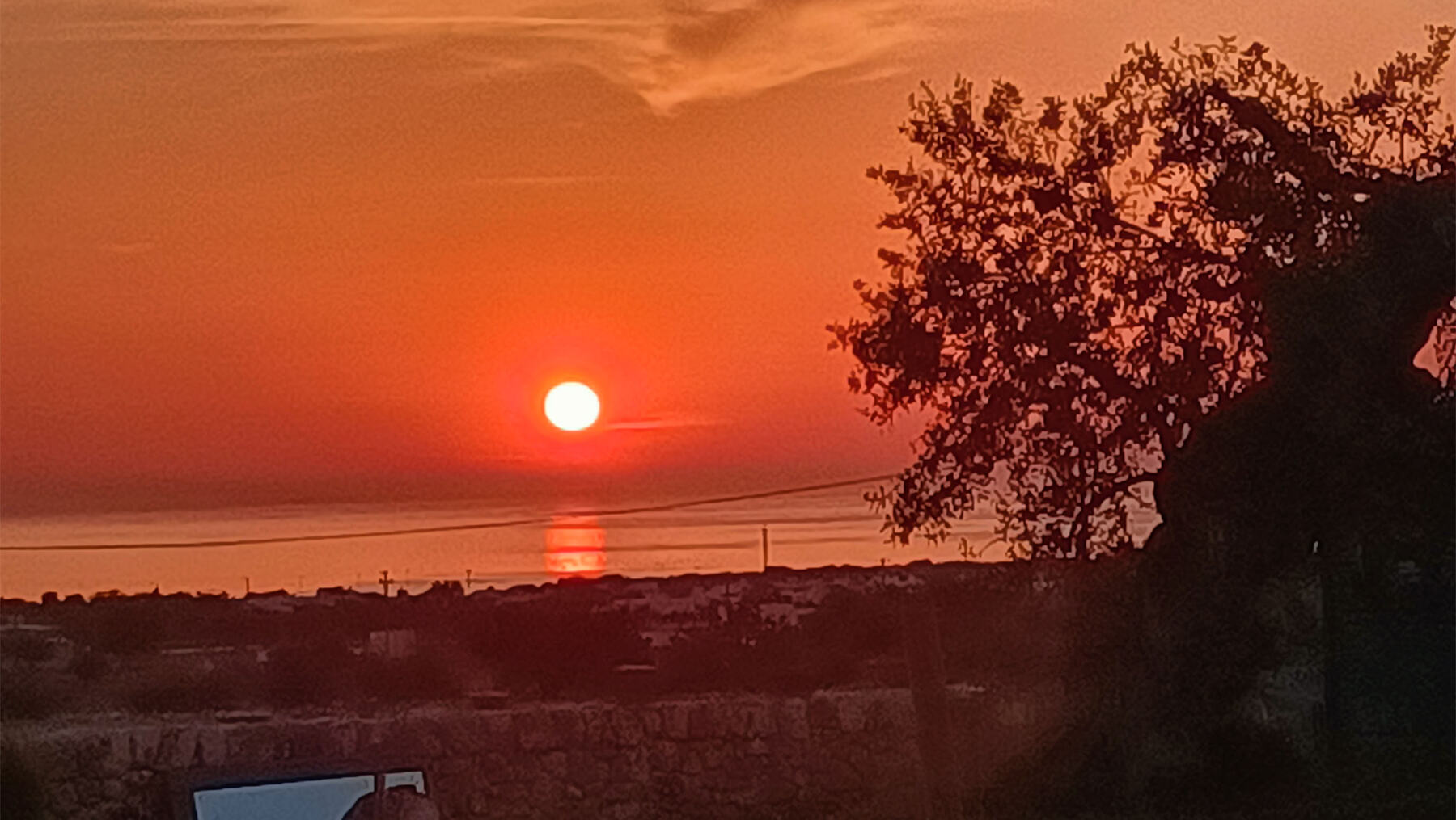 The sun setting over the sea seen from Bibiland