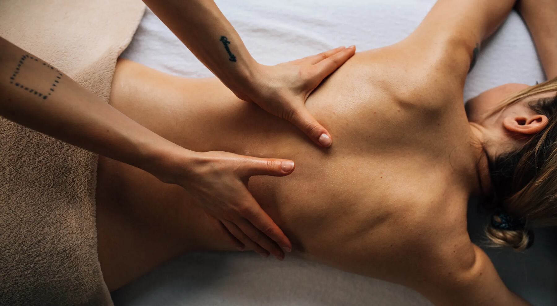 Hands treating the back during a holistic massage