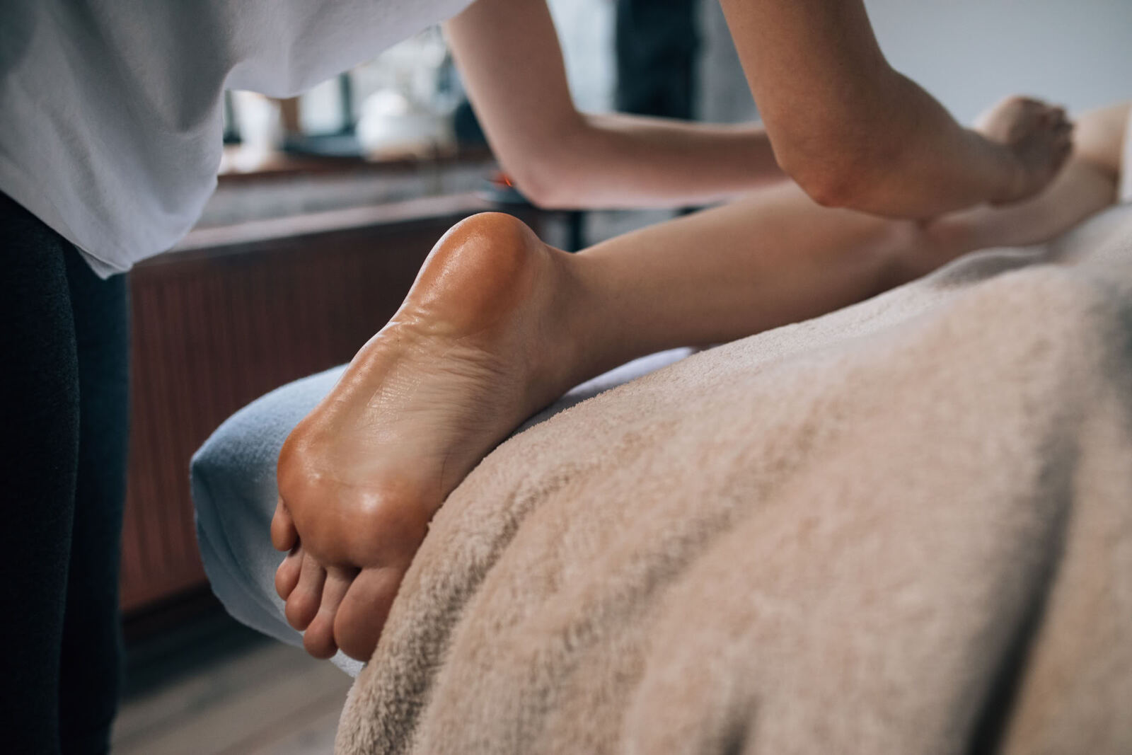 The treatment starts at the feet, with the client lying face down