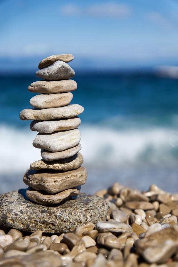 Balanced stones in front of the sea