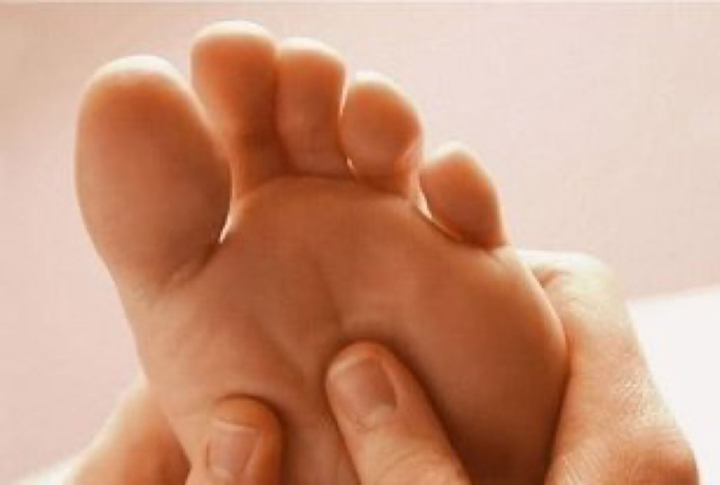 Foot reflexology: hands working on the reflex points of the foot